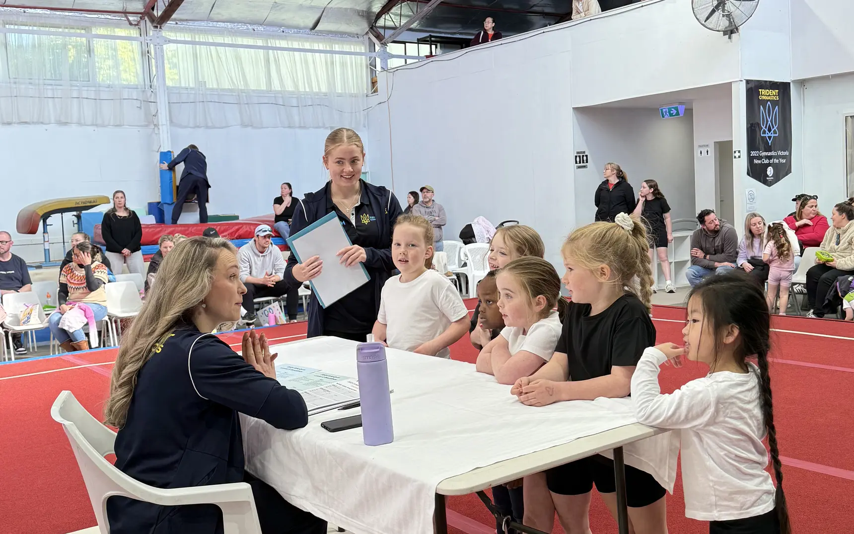 Young gymnasts talking with our friendly judges at the scoring table