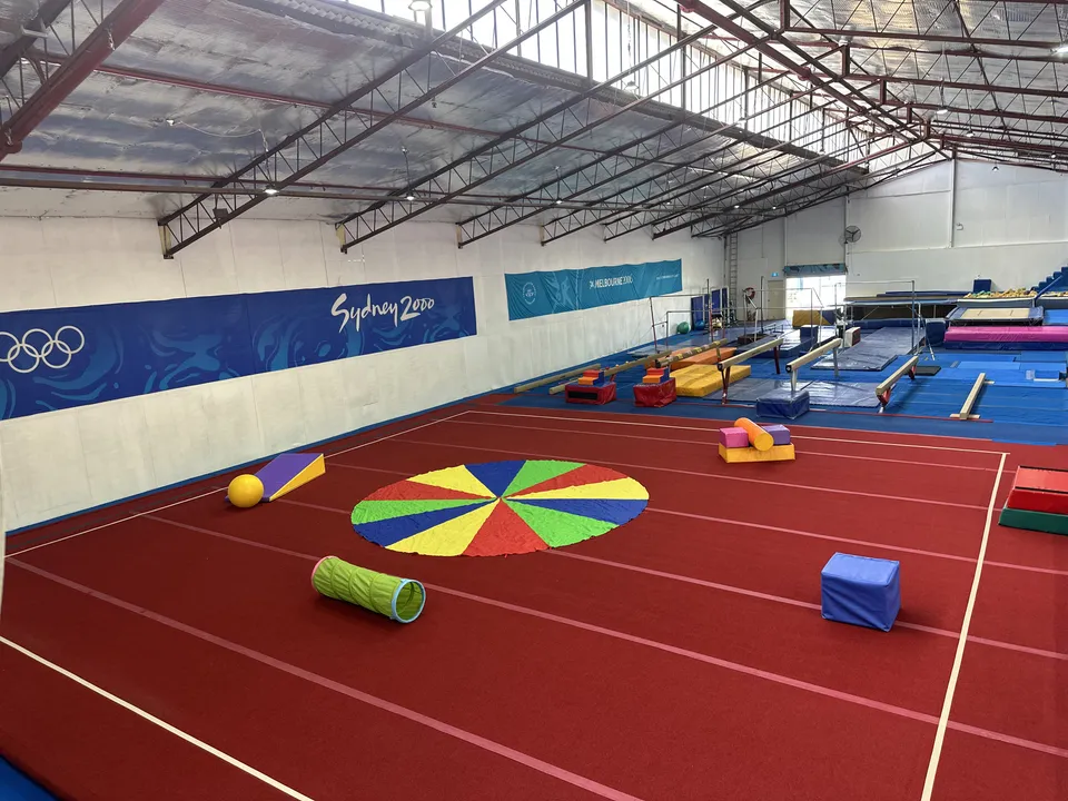 The PlayGym floor set up with a play parachute, soft rollers and foam blocks